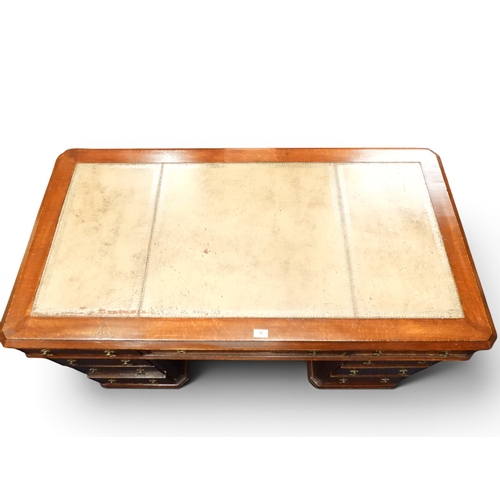 58 - A late 19th century oak partners desk with beige embossed skiver top over three frieze drawers to on... 