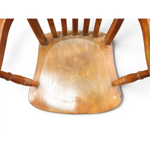 8 - A 19th century elm and beech framed high backed armchair with railed back over moulded seat flanked ...