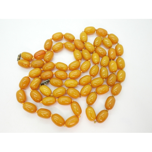 Two strings of yellow amber colour beads, each bead approx 23mm x 15mm, weight together approx 255gms