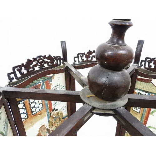 2006 - A LATE 19TH CENTURY CHINESE HARDWOOD FRAMED HEXAGONAL GLAZED LANTERNwith carved pierced frameworks a... 