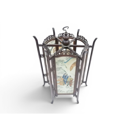 2006 - A LATE 19TH CENTURY CHINESE HARDWOOD FRAMED HEXAGONAL GLAZED LANTERNwith carved pierced frameworks a... 