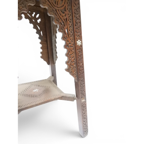 2008 - A LATE 19TH CENTURY MOORISH STYLE TWO TIER OCCASIONAL TABLE square top extensively carved with Arabi... 