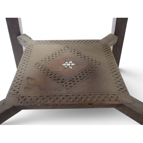 2008 - A LATE 19TH CENTURY MOORISH STYLE TWO TIER OCCASIONAL TABLE square top extensively carved with Arabi... 