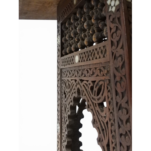 2008 - A LATE 19TH CENTURY MOORISH STYLE TWO TIER OCCASIONAL TABLE square top extensively carved with Arabi... 