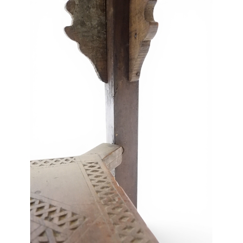 2008 - A LATE 19TH CENTURY MOORISH STYLE TWO TIER OCCASIONAL TABLE square top extensively carved with Arabi... 