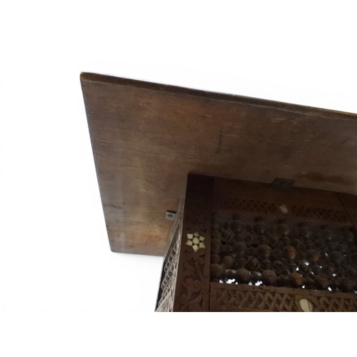 2008 - A LATE 19TH CENTURY MOORISH STYLE TWO TIER OCCASIONAL TABLE square top extensively carved with Arabi... 