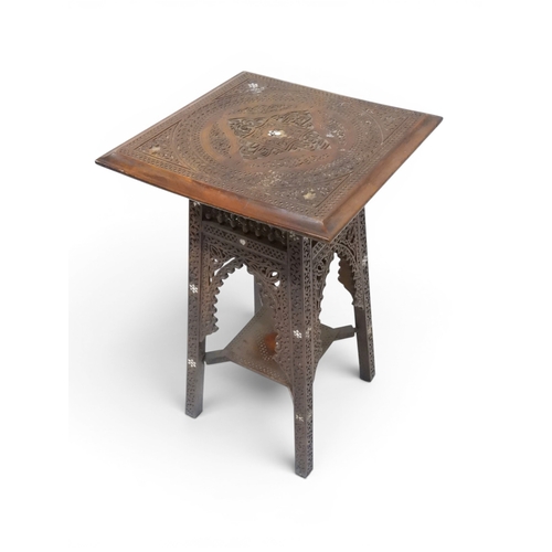 2008 - A LATE 19TH CENTURY MOORISH STYLE TWO TIER OCCASIONAL TABLE square top extensively carved with Arabi... 
