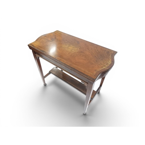 2016 - A VICTORIAN ROSEWOOD AND SATINWOOD INLAID FOLD-OVER CARD TABLE&nbsp;shaped top concealing baize line... 