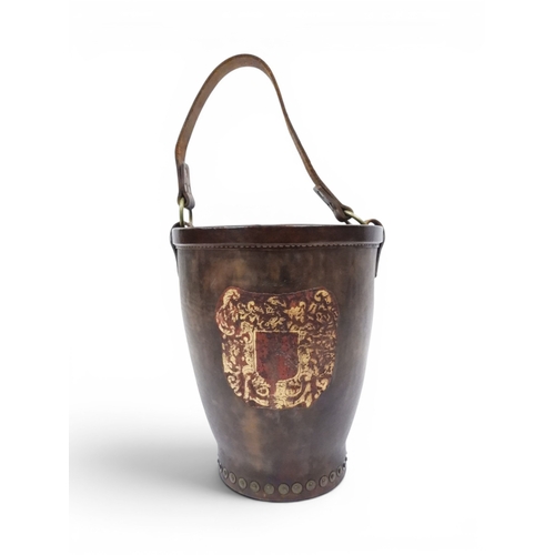 2018 - A 20TH CENTURY REPRODUCTION OF AN EARLY 19TH CENTURY LEATHER FIRE BUCKETwith brass rivetted body emb... 
