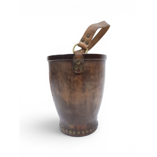 2018 - A 20TH CENTURY REPRODUCTION OF AN EARLY 19TH CENTURY LEATHER FIRE BUCKETwith brass rivetted body emb... 