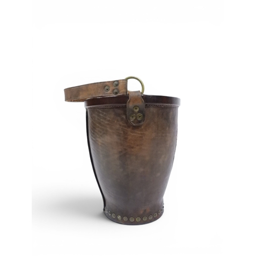 2018 - A 20TH CENTURY REPRODUCTION OF AN EARLY 19TH CENTURY LEATHER FIRE BUCKETwith brass rivetted body emb... 