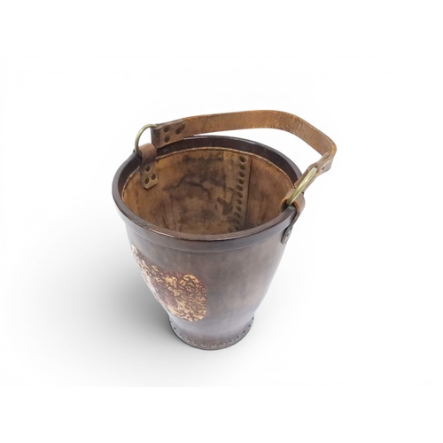 2018 - A 20TH CENTURY REPRODUCTION OF AN EARLY 19TH CENTURY LEATHER FIRE BUCKETwith brass rivetted body emb... 