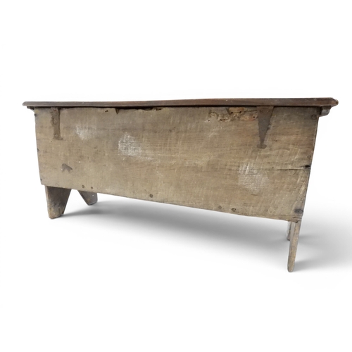 2020 - AN 18TH CENTURY OAK SWORD CHESTwith two plank hinged lid with wrought iron fittings on fret cut supp... 