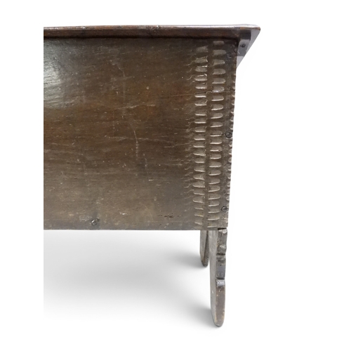 2020 - AN 18TH CENTURY OAK SWORD CHESTwith two plank hinged lid with wrought iron fittings on fret cut supp... 