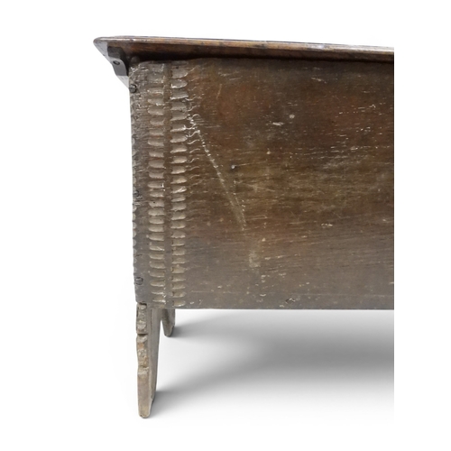 2020 - AN 18TH CENTURY OAK SWORD CHESTwith two plank hinged lid with wrought iron fittings on fret cut supp... 
