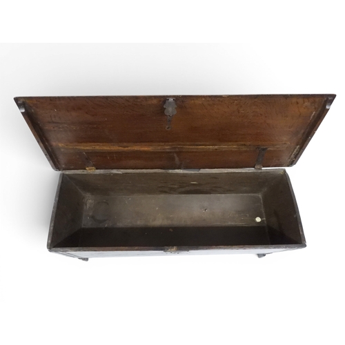 2020 - AN 18TH CENTURY OAK SWORD CHESTwith two plank hinged lid with wrought iron fittings on fret cut supp... 