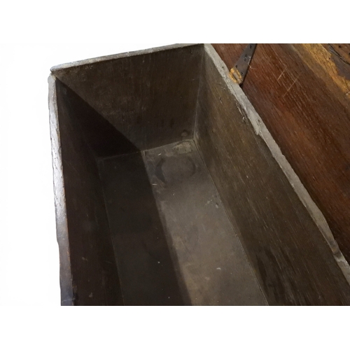 2020 - AN 18TH CENTURY OAK SWORD CHESTwith two plank hinged lid with wrought iron fittings on fret cut supp... 