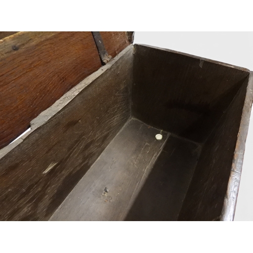 2020 - AN 18TH CENTURY OAK SWORD CHESTwith two plank hinged lid with wrought iron fittings on fret cut supp... 