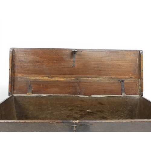 2020 - AN 18TH CENTURY OAK SWORD CHESTwith two plank hinged lid with wrought iron fittings on fret cut supp... 