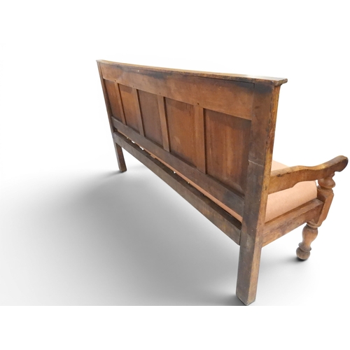 2021 - AN 18TH CENTURY OAK FIVE PANEL BACK SETTLEwith shaped scroll arms flanking later upholstered drop in... 