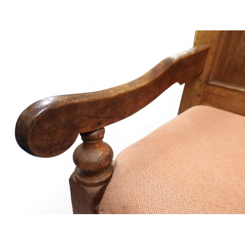 2021 - AN 18TH CENTURY OAK FIVE PANEL BACK SETTLEwith shaped scroll arms flanking later upholstered drop in... 