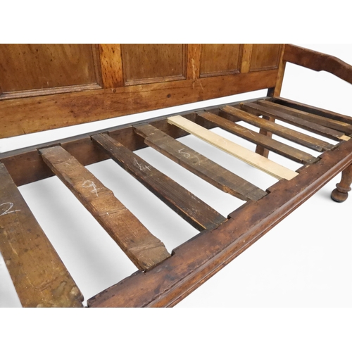 2021 - AN 18TH CENTURY OAK FIVE PANEL BACK SETTLEwith shaped scroll arms flanking later upholstered drop in... 
