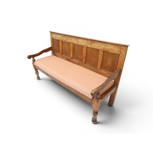 2021 - AN 18TH CENTURY OAK FIVE PANEL BACK SETTLEwith shaped scroll arms flanking later upholstered drop in... 
