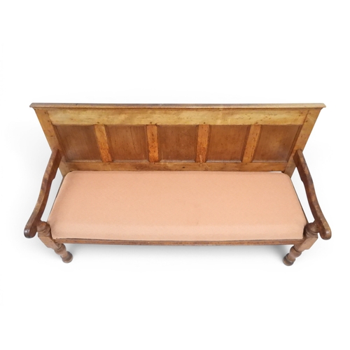 2021 - AN 18TH CENTURY OAK FIVE PANEL BACK SETTLEwith shaped scroll arms flanking later upholstered drop in... 