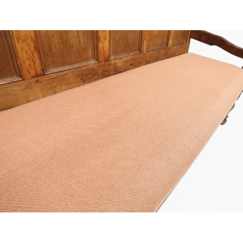 2021 - AN 18TH CENTURY OAK FIVE PANEL BACK SETTLEwith shaped scroll arms flanking later upholstered drop in... 
