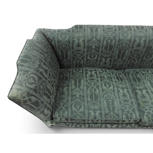 2058 - A LATE 19TH CENTURY GREEN UPHOLSTERED HUMPBACK SETTEE&nbsp;with raised arms on carved scrolled front... 