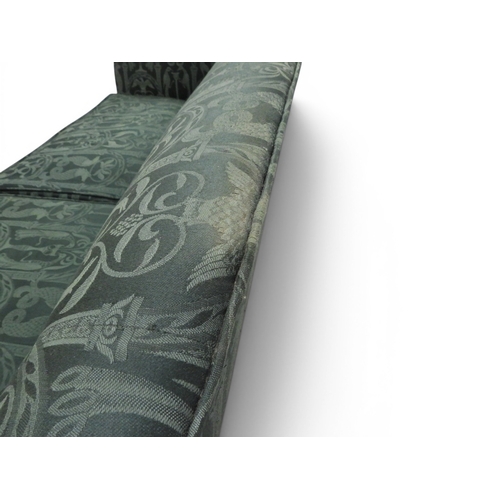 2058 - A LATE 19TH CENTURY GREEN UPHOLSTERED HUMPBACK SETTEE&nbsp;with raised arms on carved scrolled front... 