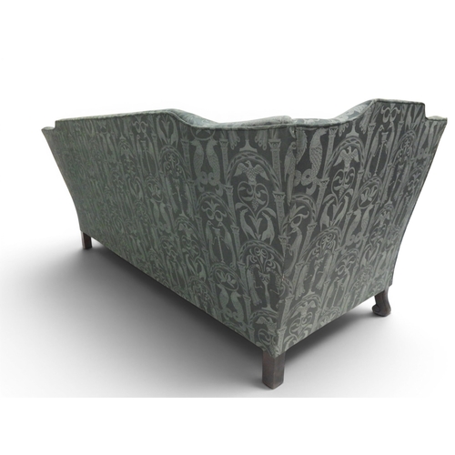 2058 - A LATE 19TH CENTURY GREEN UPHOLSTERED HUMPBACK SETTEE&nbsp;with raised arms on carved scrolled front... 