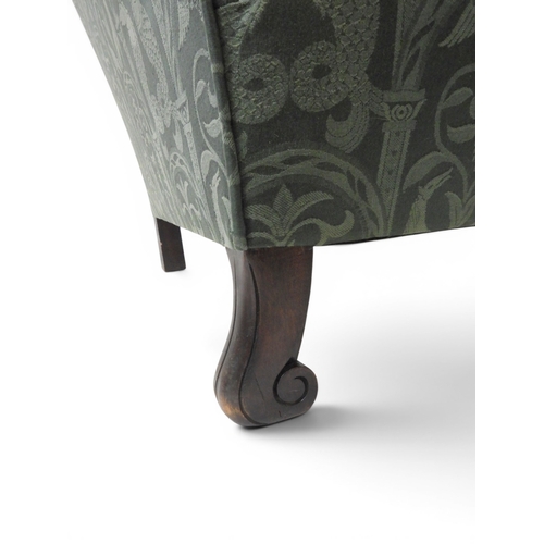 2058 - A LATE 19TH CENTURY GREEN UPHOLSTERED HUMPBACK SETTEE&nbsp;with raised arms on carved scrolled front... 