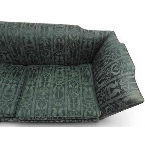 2058 - A LATE 19TH CENTURY GREEN UPHOLSTERED HUMPBACK SETTEE&nbsp;with raised arms on carved scrolled front... 