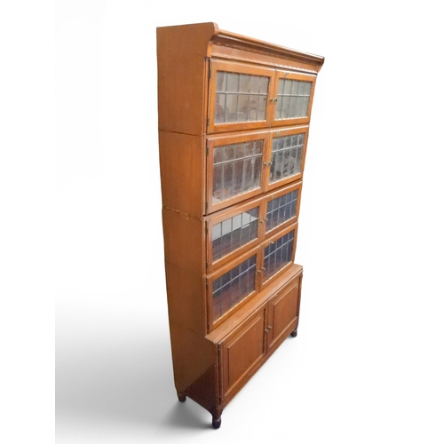 2003 - AN EARLY 20TH CENTURY MAHOGANY MINTY LIMITED, OXFORD FIVE TIER SECTIONAL BOOKCASEwith four pairs of ... 