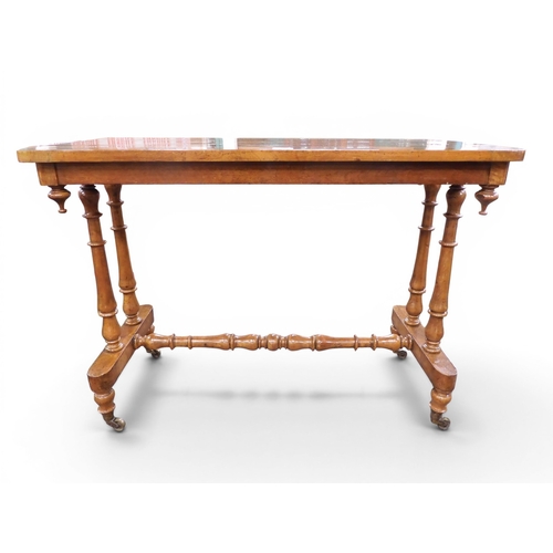 18 - A Victorian walnut veneered side table on turned trestle supports joined by single turned stretcher,... 