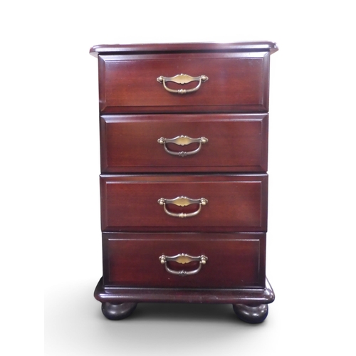 34 - A late 20th century mahogany veneered four drawer bedside chest with metallic drawer pulls on bun fe... 