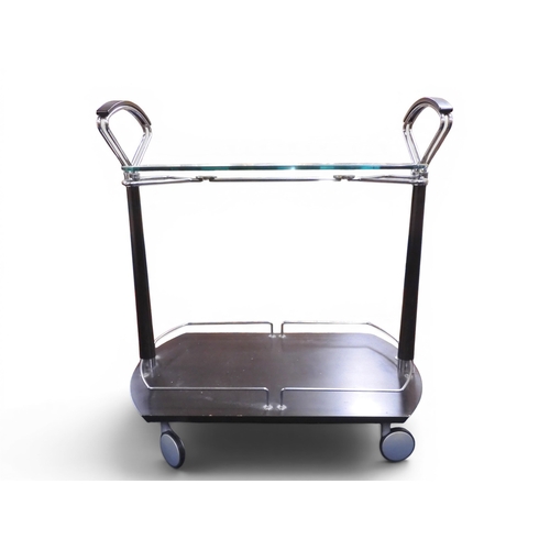 43 - A late 20th century Italian IMS modernist drinks/cocktail trolley with shaped glass top on dark stai... 