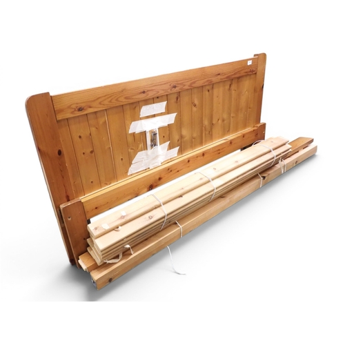 50 - A 20th century rustic pine king size bedframe, 77cm high x 153cm wide x 206cm long