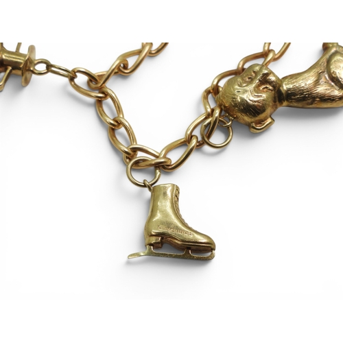 701 - A 9ct gold charm bracelet to include a 9ct Bonzo Dog charm, a horses head and a further 6 9ct charms... 