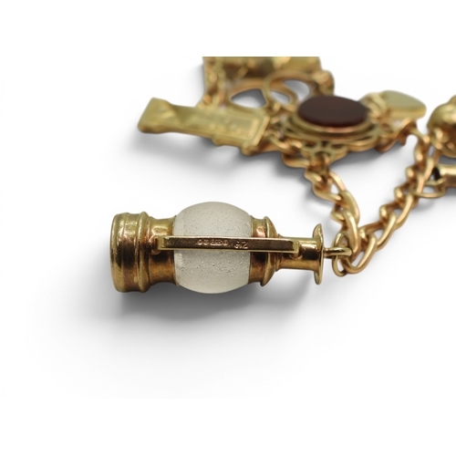 701 - A 9ct gold charm bracelet to include a 9ct Bonzo Dog charm, a horses head and a further 6 9ct charms... 