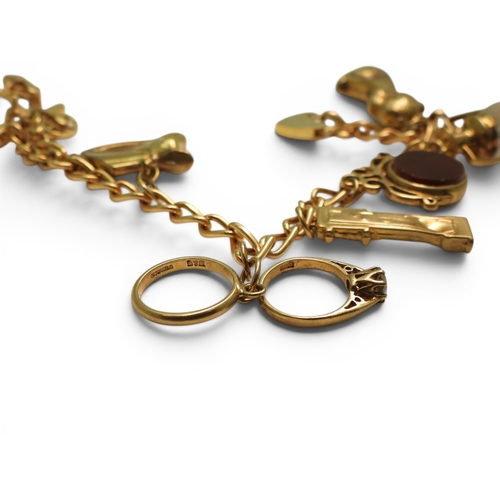 701 - A 9ct gold charm bracelet to include a 9ct Bonzo Dog charm, a horses head and a further 6 9ct charms... 