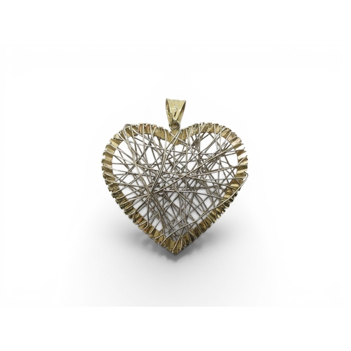 708 - A 14k gold heart pendant with wire work design, weight 6.1gms