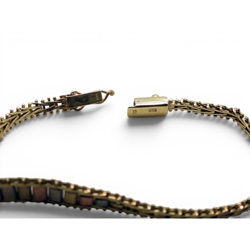 712 - A collection of 9ct gold items, a wishbone pendant, a tricolour bracelet, a 'J' pendant and a St. Ch... 
