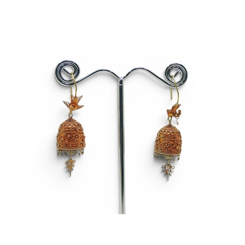 713 - A pair of yellow metal filigree and wire work earrings in the shape of a bell surmounted by a bird, ... 