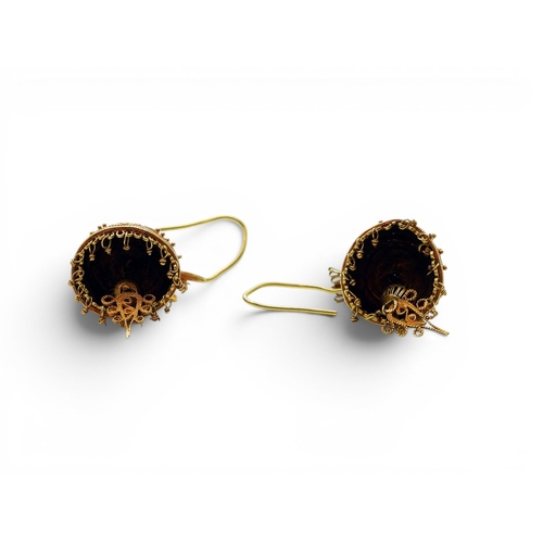 713 - A pair of yellow metal filigree and wire work earrings in the shape of a bell surmounted by a bird, ... 