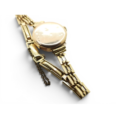 724 - A 9ct gold ladies Audax watch and strap, weight including 9ct strap and the mechanism 15.4gms