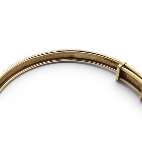 728 - A 9ct gold expanding bangle, with engraved pattern, weight 7.2gms