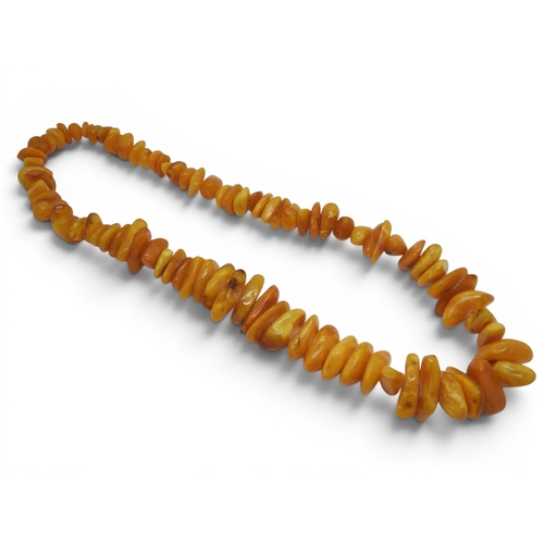 730 - A very large statement yellow amber coloured tumbled bead necklace, tapering in size from approx 2cm... 