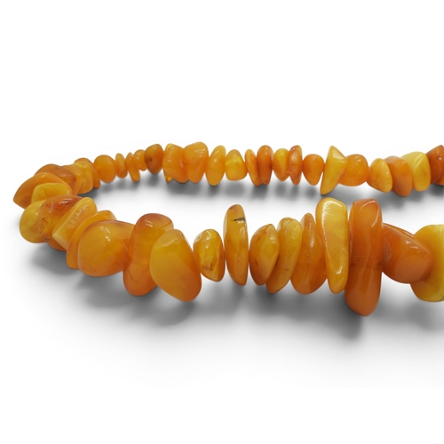 730 - A very large statement yellow amber coloured tumbled bead necklace, tapering in size from approx 2cm... 